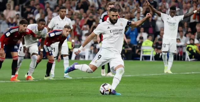 Karim Benzema kicks the penalty (Reuters)
